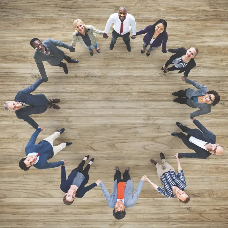 aerial-view-diverse-business-people-holding-hands-togeher-teamwork