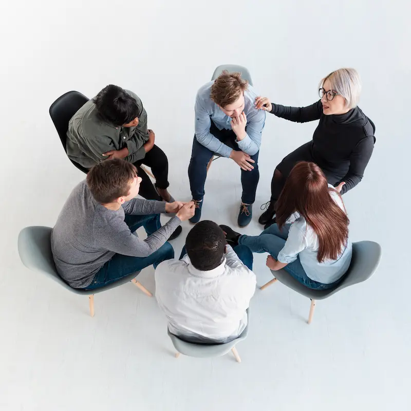 top-view-rehab-patients-standing-circle-talking